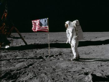 Astronaut Buzz Aldrin beside US flag © NASA