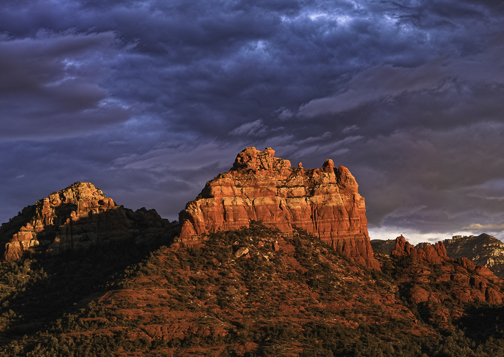 Sunsets on Sedona red rocks as storm clouds gather