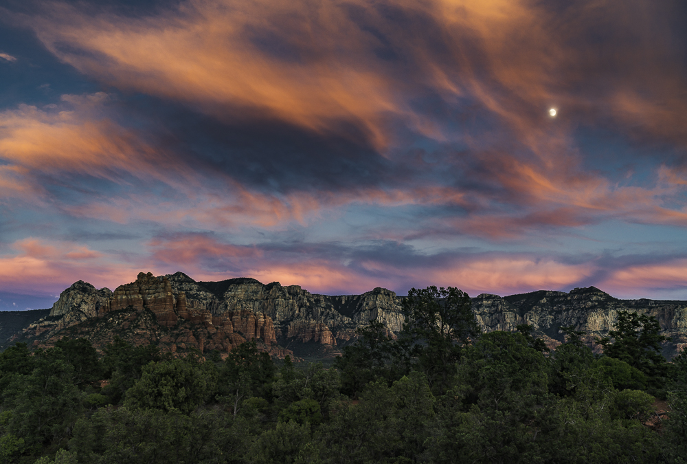 Wild red clouds and moonrise over the Mogollon Rim