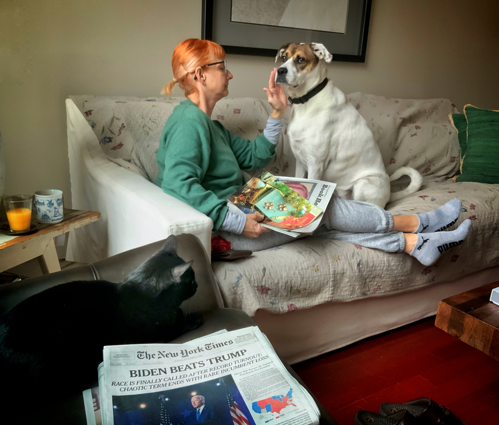 Debra on a relaxing Sunday morning. Ansel the cat and Maggie with the New York Times.
