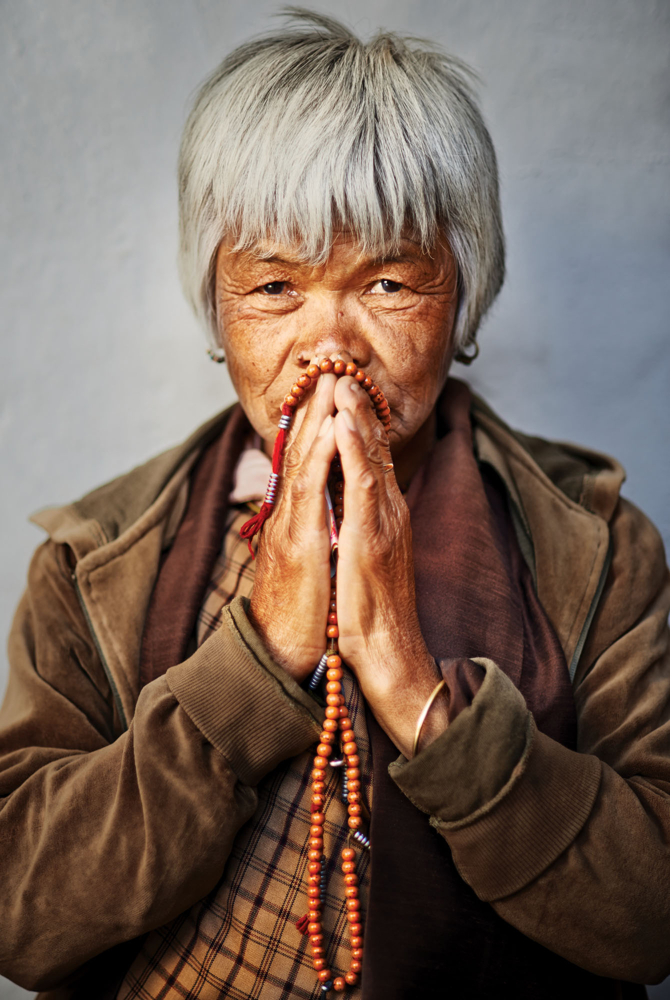 Lady praying, Bhutan. Should I have paid to take this photo? My conscience is clear! Nikon D800, 85mm lens, f2 @ 1/400 second, ISO 200.