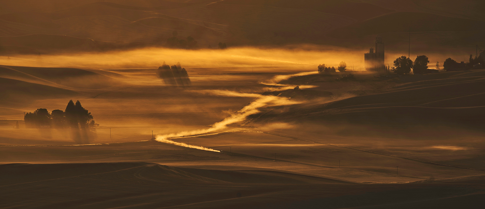 The ride home, dust trail, Palouse, 400mm lens in the Palouse