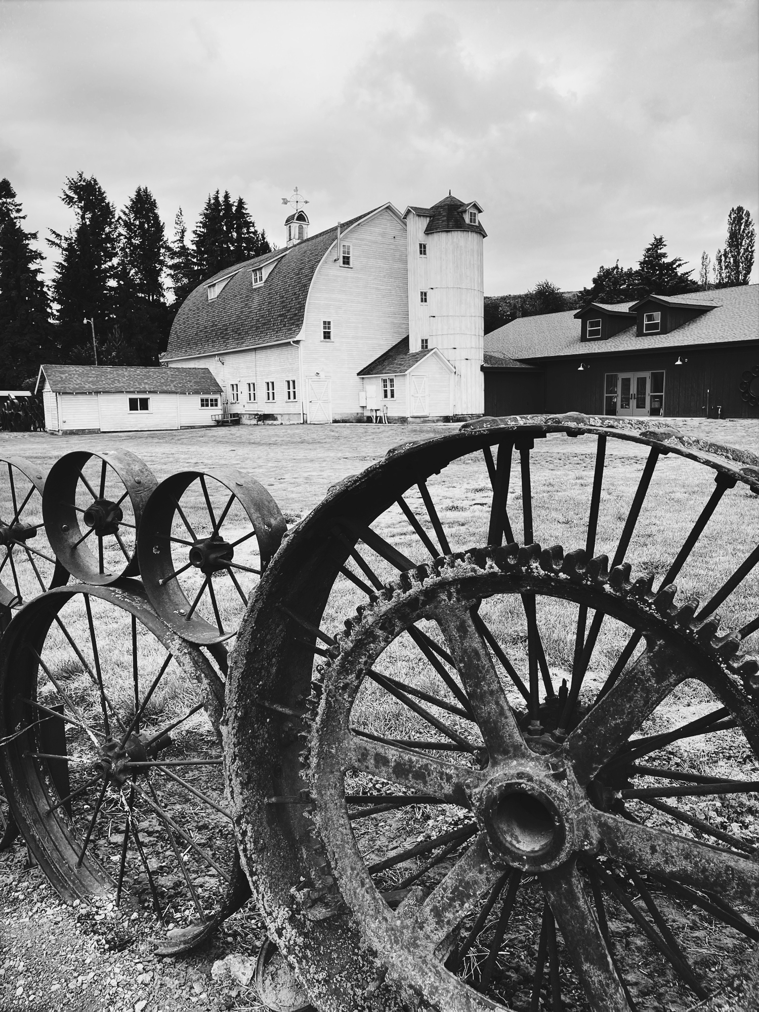 This is an artisians craft barn surrounded by an iron wagon wheel fence