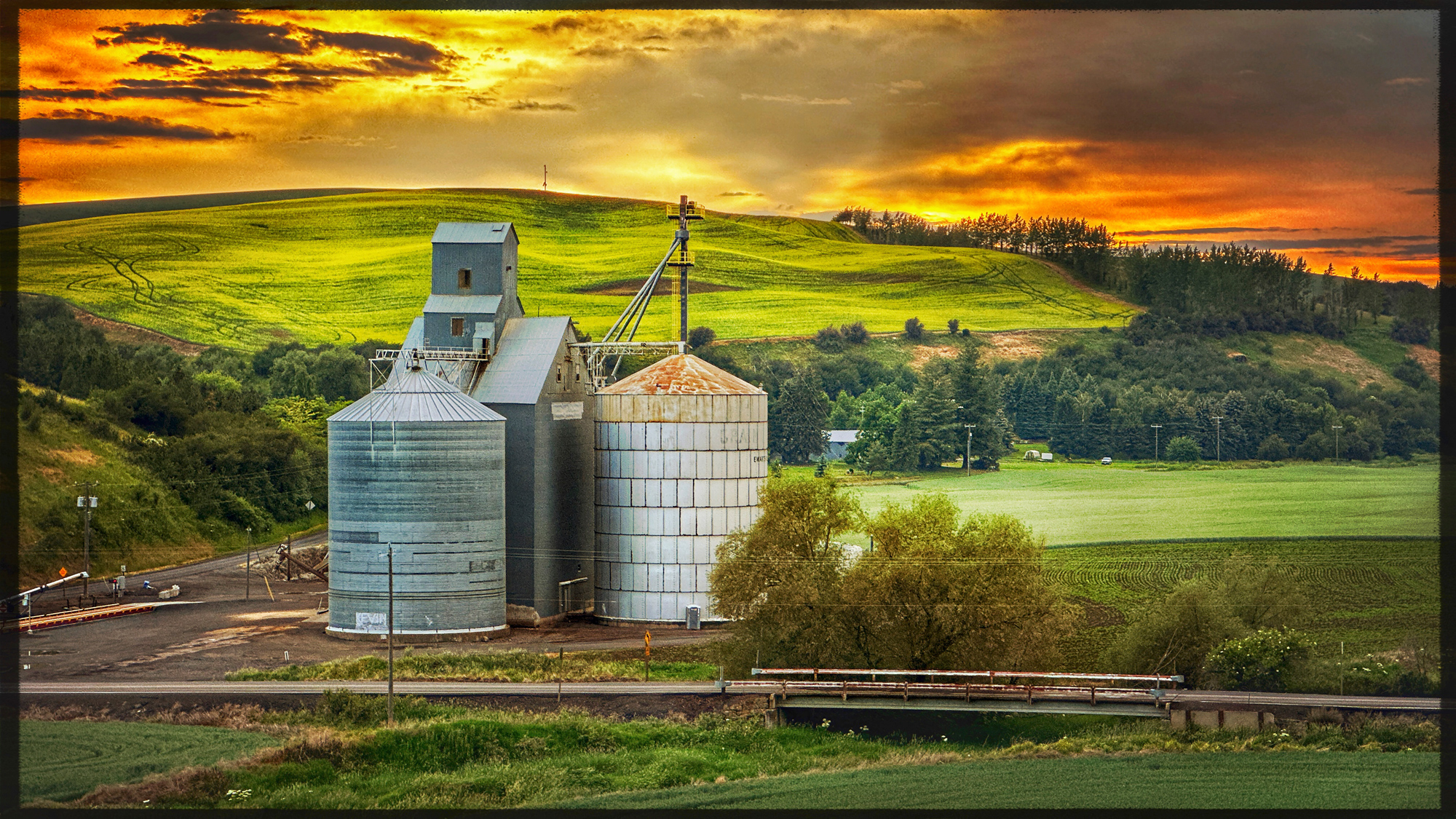 This is kind of iconic for the Palouse. Grain Silos, hillsides with crops and a sunset with amazing clouds.