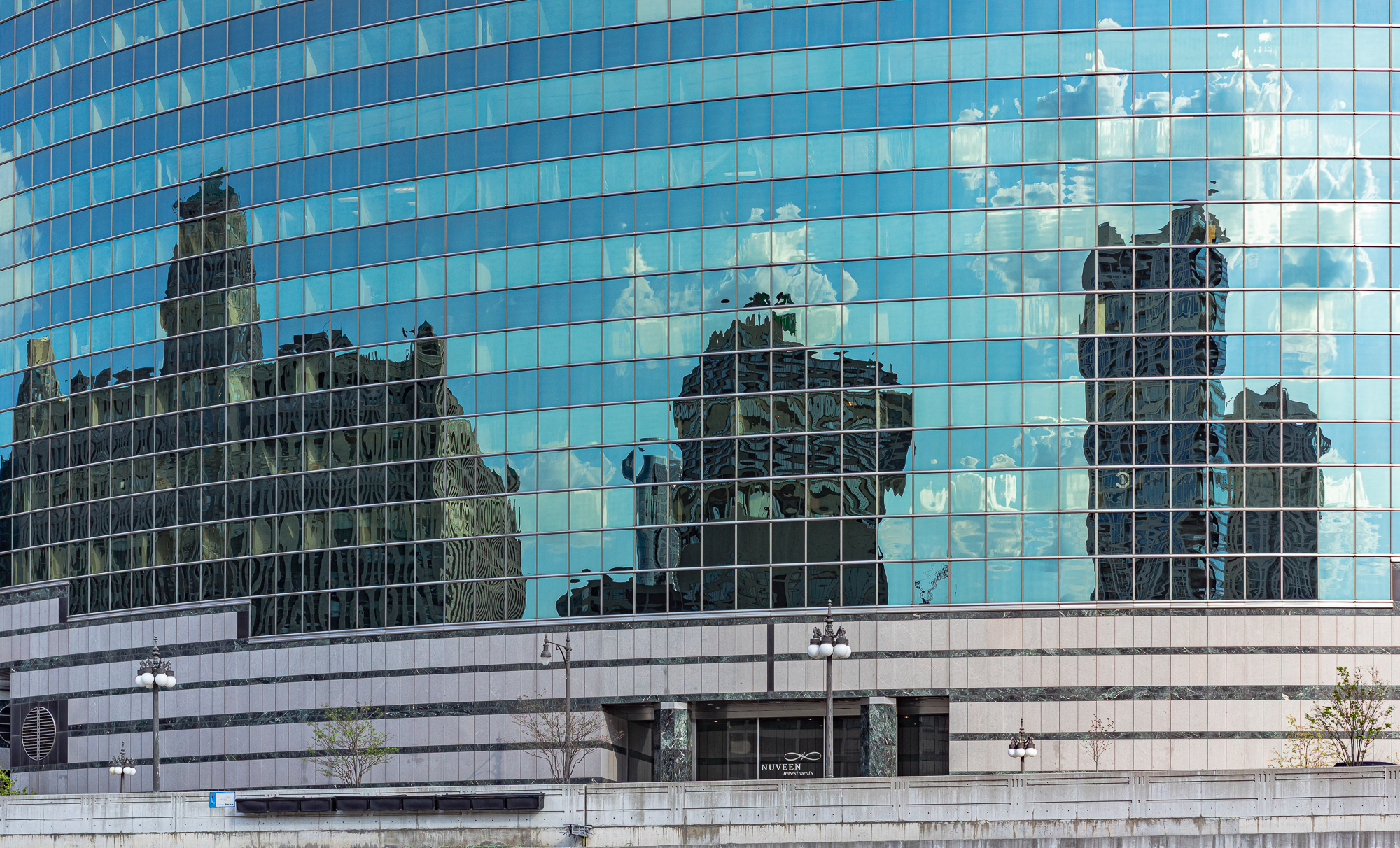 Glass windows distort reflections of nearby buildings